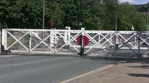 Zoom in on opening level crossing gates Stock Footage 12615655