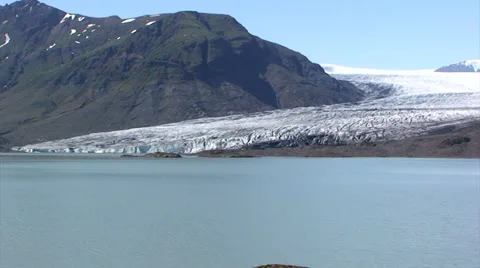 Zoom out on ablation zone glacier tongue in front of lake Stock Footage 37782387