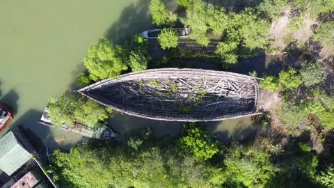 Zoom out aerial view of a large broken boat parked on the bank of the river Stock Footage 246777680