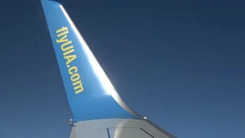 Zoom out airplane wing during flight above clouds Stock Footage 139515533