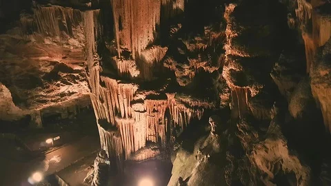 Zoom out from an ancient rock formation drapes on a tall column in Saeva Cave Stock Footage 86334739
