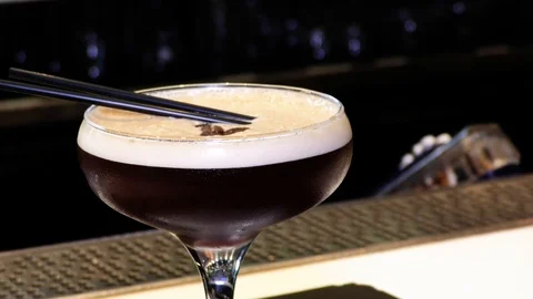 Zoom out and focus pull of Espresso Martini cocktail Stock Footage 106519381