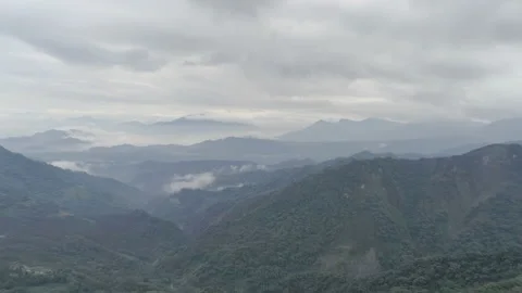 Zoom out and pan move. Aerial drone shot of foggy hills in Taiwan Stock Footage 187920207