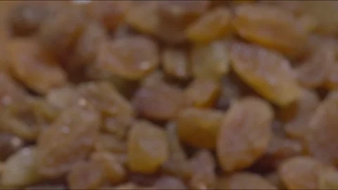 A zoom out and steady shot of Golden Raisins on a table Stock Footage 280339085