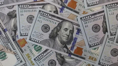 Zoom out from background of many scattered one hundred US dollar bills Stock Footage 334662831