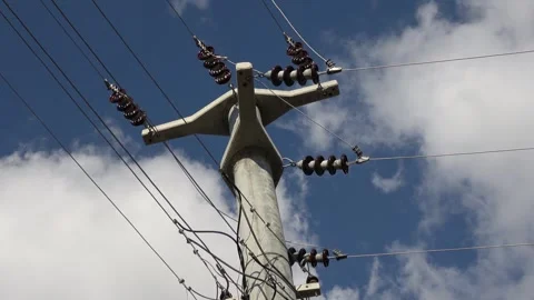 Zoom out Bottom view on a concrete electric pole against the sky Video stock 297607302