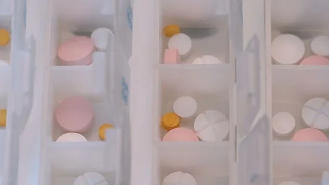 Zoom out from boxes for daily use with pills Stock Footage 102627042