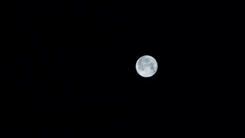 Zoom out bright moon in the night sky Stock Footage 101362278