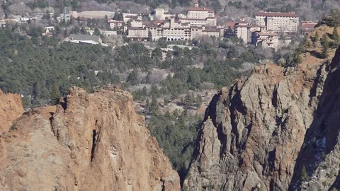 Zoom out of the Broadmoor through cliffs, canyons and mountains Stock Footage