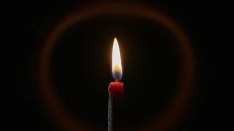 Zoom out candle flame with soft halo on pitch black background. Wax taper blazes Stock Footage 332512403