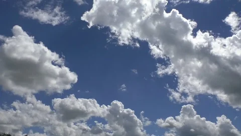 Zoom out from a clear blue sky to reveal clouds, type altocumulus castellanus Stock Footage 76774191