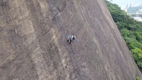 Zoom out of climbers on the mountain on a cloudy day. Stock Footage 81138285