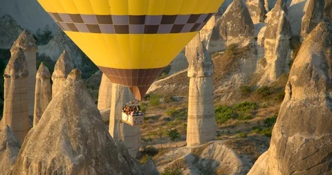 Zoom out from close up of Hot air balloons flying over "Love Valley", Goreme  Stock Footage 104124555