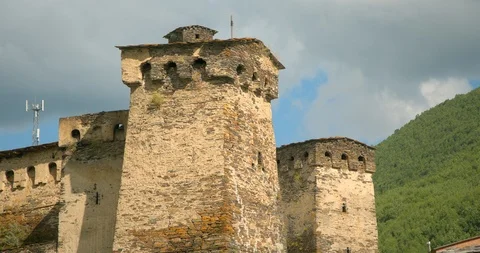 Zoom out from close up of Stone medieval fortified Svaneti tower houses of  Ushg Stock Footage 104395616
