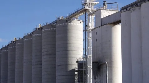 Zoom out of Concrete Grain Elevator / Crop Production Facility Stock Footage 73024388