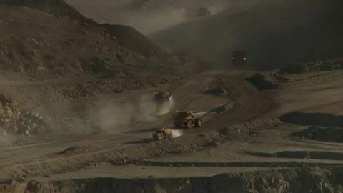 Zoom out of construction vehicles on opencast mine Stock Footage 312400373