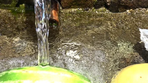 Zoom out cooling food products in cold spring water well Stock Footage 113122653