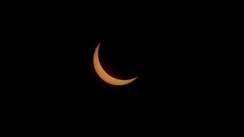 Zoom-out on crescent sun during solar eclipse. Stock Footage 274039377