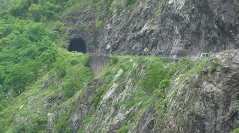 Zoom out of the dangerous road by the river canyon Stock Footage 33635076