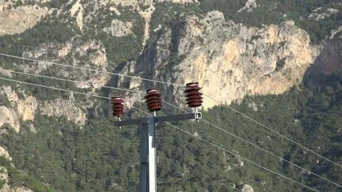Zoom out distribution electric pole against green mountains Stock Footage 297607341