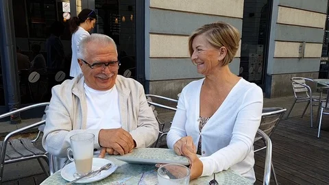 Zoom out elderly couple looking at modern expensive tablet Stock Footage 127182427