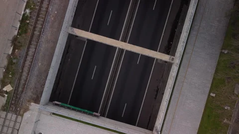 Zoom out from an empty underground road, top view, railway tracks parallel Video stock 250325431
