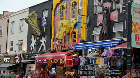ZOOM OUT from the famous wall decorations above tourist shops on Camden High Stock Footage 129285341