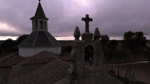 Zoom out flight from drone view from the bell tower and Christian cross of a Stock Footage 261383474