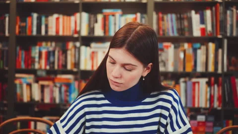 Zoom out Focused Student Studying in Library Stock Footage 282602281