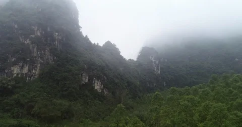 Zoom out: Foggy Mountain Landscape with Forest/Jungle Stock Footage