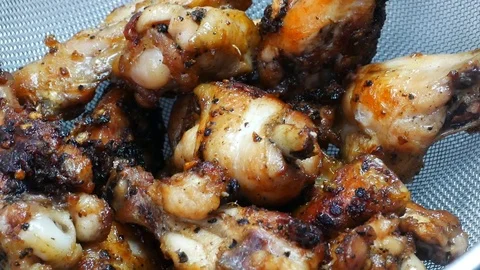 Zoom out fried leg chicken in the sieve Stock Footage 89514448