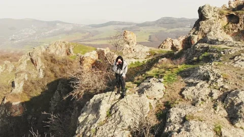 Zoom out front view attractive caucasian woman photographing mountains with D 스톡 동영상 152447190