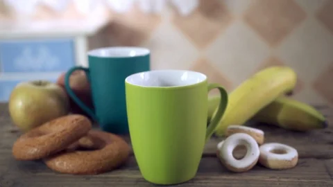 Zoom out of healthy breakfast with ceramic mugs of different colors Stock Footage 102066184