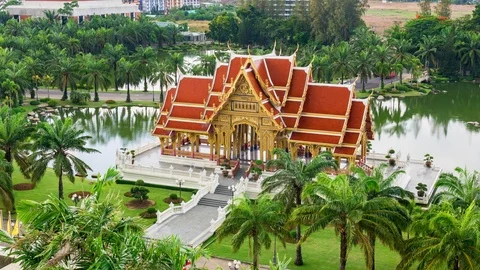 Zoom out high angle timelapse of Thai Pavilion on side of lake on rainy day Stock Footage 111166419
