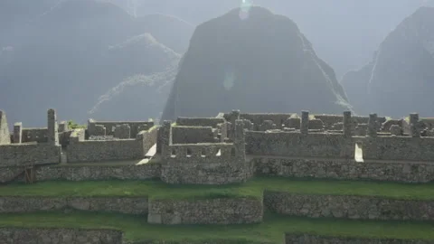 Zoom out to Machu Picchu lost city sunny day with peruvian mountains Stock Footage 285864108