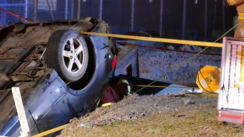 Zoom out of a major car accident during high angle rescue Stock Footage 101989788