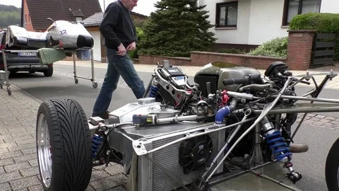 Zoom out: Man taking care of his sidecar machine, Racing motorbike and sidecar Stock Footage 76769085
