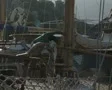 Zoom out from man untying moorings SD Footage