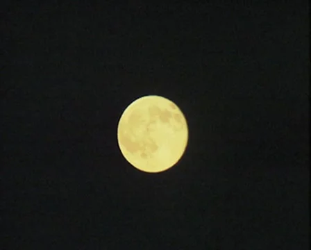 Zoom out from moon in night sky and ship lights Stock Footage
