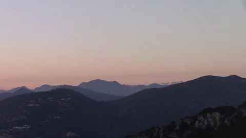 Zoom out of a mountain landscape at sunset Stock Footage 71084402
