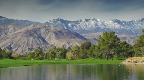 Zoom Out from Mountains Overlooking a Golf Course and Lake Stock Footage 66518077