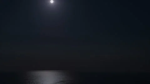 Zoom-out night time lapse. Full moon on the night sky over sea with lunar path Stock-Footage 232987787