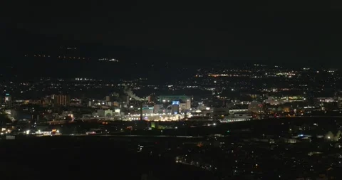 Zoom out from the night view of Ueda city in Nagano, Japan Stock Footage 334680157