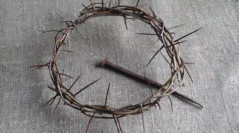Zoom out over crown of thorns and large nail on burlap. Stock Footage 67186533