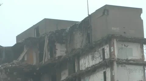 Zoom out from partially demolished tower block, open floors with graffiti Stock-Footage 14772004