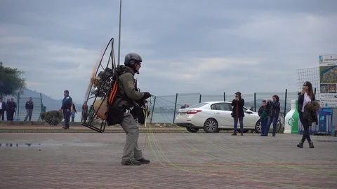 Zoom out Pilot of paragliding machine having problem with the engine Stock-Footage 86888134