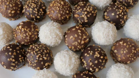 Zoom out from a plate of sweets. Chocolate and coconut snack on a plate Stock Footage 342501212