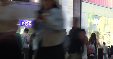 Zoom out from Pop Mart neon logo to crowd in SHANGHAI, CHINA Stock Footage 344992705