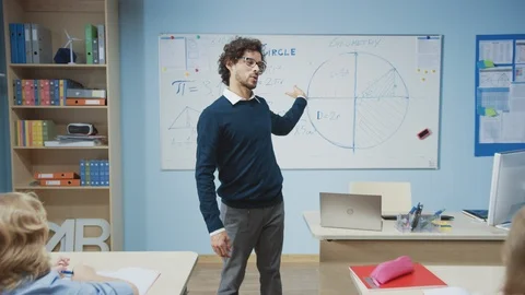 Zoom Out Portrait of Teacher Explaining Lesson to Classroom Full of Children Stock Footage 119444466