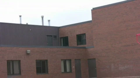 Zoom out of red bricked school and school yard Stock Footage 517992